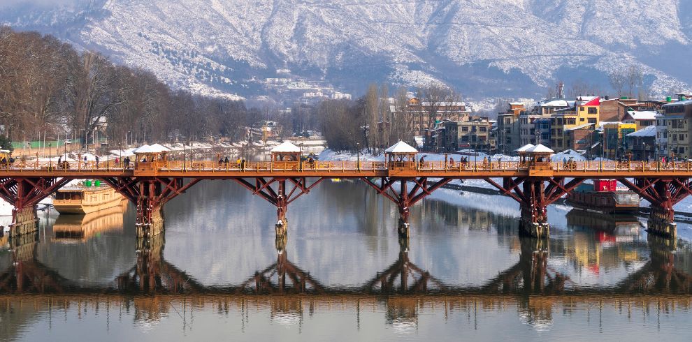 In cheapest Kashmir tour package, many people enjoying their tour over the  beautiful bridge in Srinagar, Kashmir.